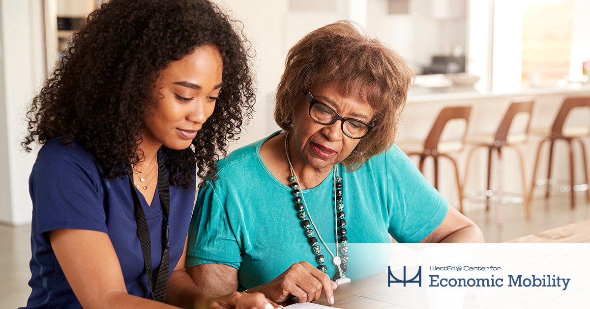 Two women are reviewing a document.