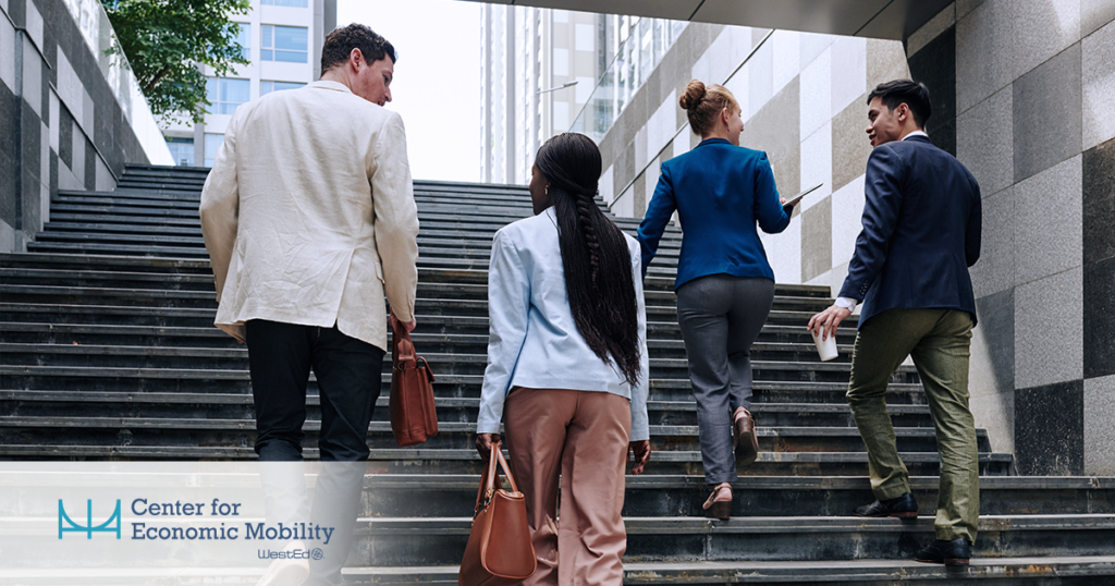 Four professionals in business attire walk up a wide outdoor staircase between modern office buildings; the “Center for Economic Mobility, WestEd” logo appears in the lower-left corner.